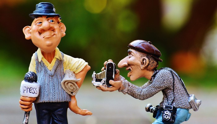 Deux figurines: un journaliste avec un micro et un photographe