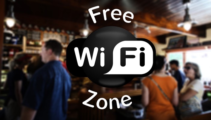 "Free Wifi Zone" et à l'arrière plan on voit un bar remplit de gens