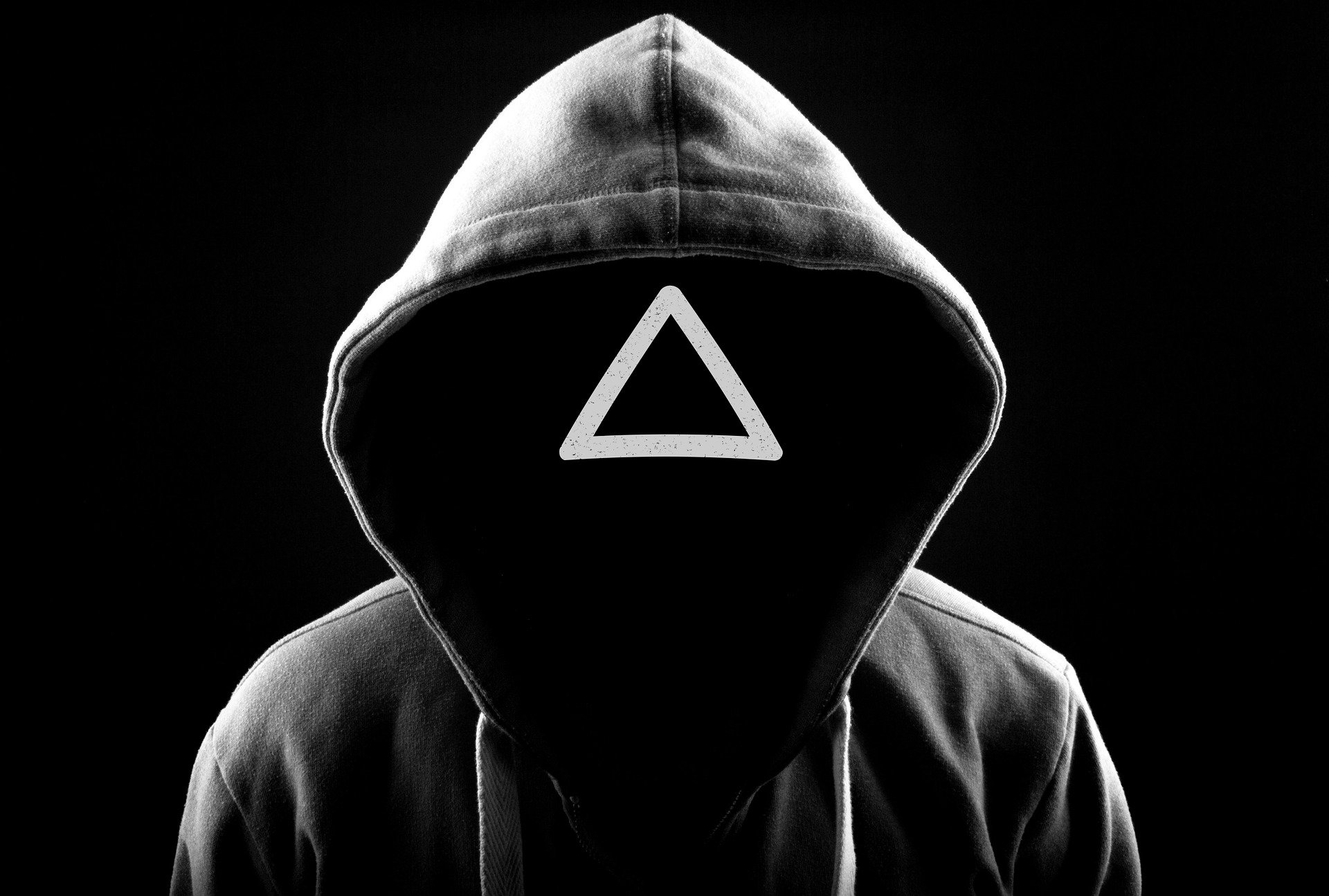 Maskierte Person mit Dreieck Symbol im Gesicht