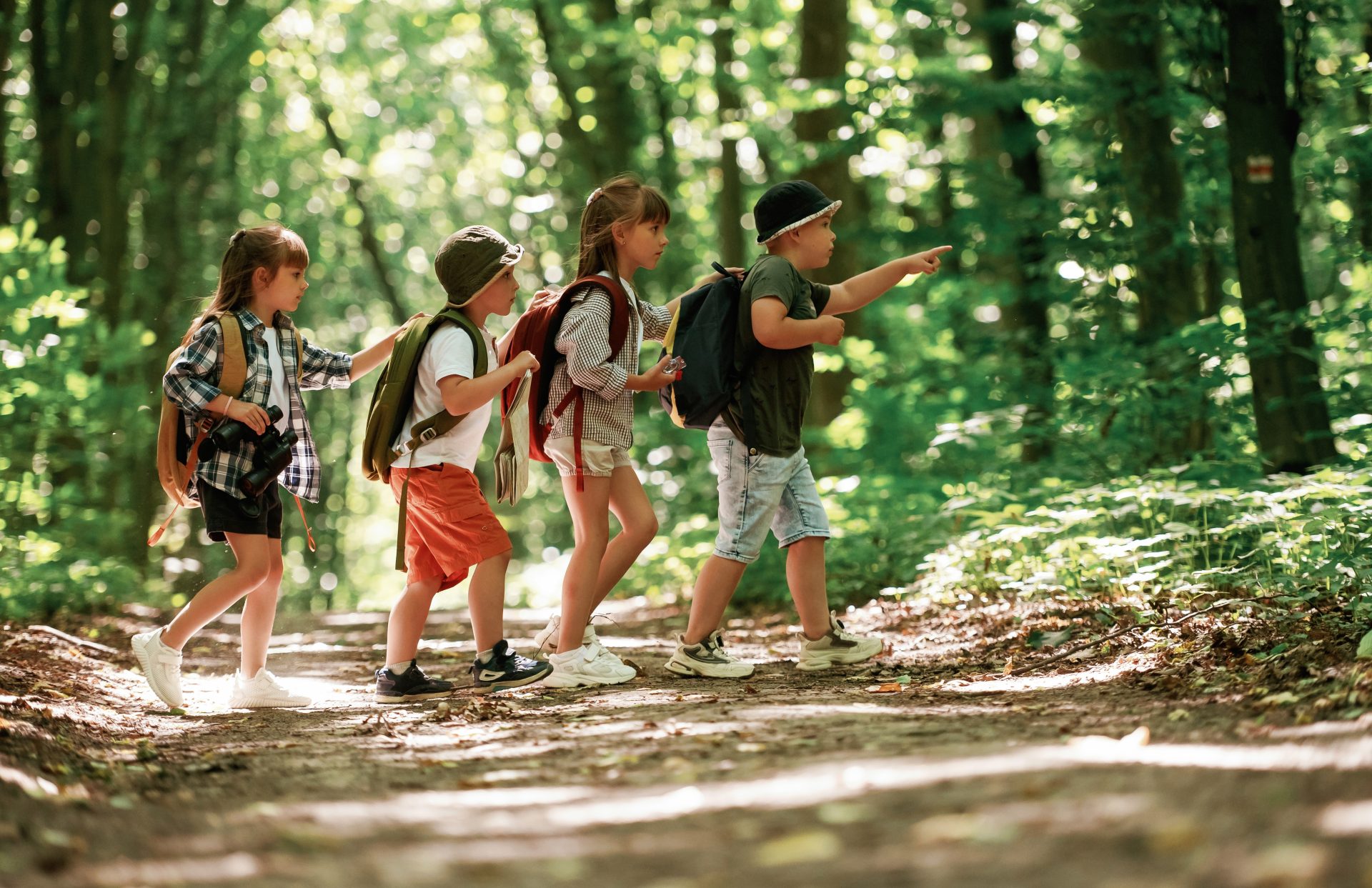 Kinder entdecken den Wald mit freudiger Neugier anstatt zuhause am Bildschirm zu sitzen.